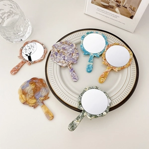 Portable rose-shaped and wavy round acetate hand mirrors in various marble textures
