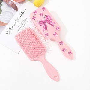 Set de brosses à cheveux roses avec motif nœud scintillant et coussin massant