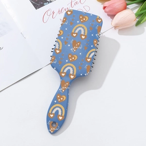 Detail of bohemian air cushion hair brush with colorful patterns and massage bristles