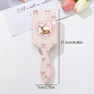 Macro view of pink paddle brush featuring deer and bow prints with 21.5cm x 7cm size detail