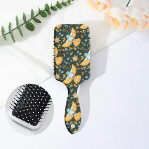 Detail of floral printed hairbrush with nylon bristles and ergonomic handle design