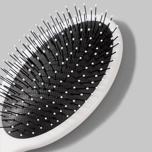 Oval Halloween massage cushion hairbrush with black bristles and white protective tips