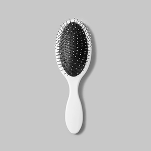 Detailed view of the soft black air cushion and white massage bristles on the hairbrush