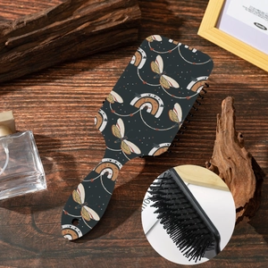 Close-up of air cushion massage hairbrush with butterfly pattern on dark blue base