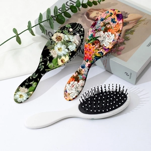 Floral pattern vintage cushion hairbrush set with scalp massage bristles on white background