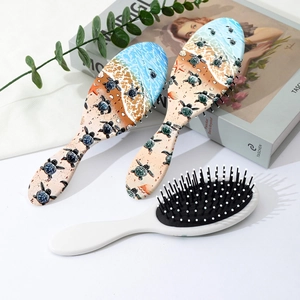 Three-piece hair brush set with sea turtle ocean pattern and white cushion massage bristles