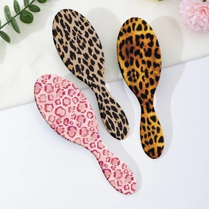 Three-piece set of oval leopard print hair brushes with ergonomic anti-static air cushions