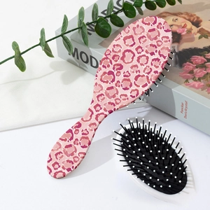Detail of pink leopard print hairbrush with anti-static bristles and massage tips