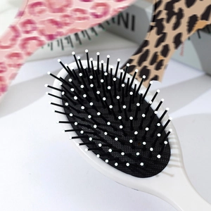 Portable leopard print cushion hairbrush with anti-static bristles and massage tips