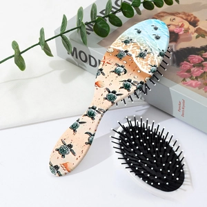 Detail of sea turtle print massage hairbrush set on a stylish lifestyle background