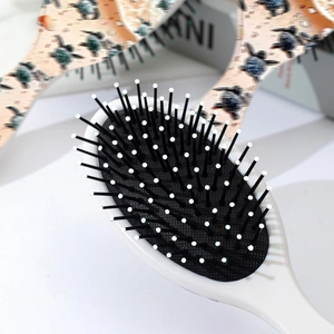 Oval ocean theme cushion hairbrush featuring a decorative sea turtle print on white ABS frame