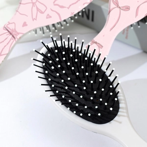 Brosse à cheveux rose avec motif de nœud cerise et coussin d'air pour massage