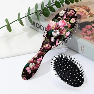 Detail of floral massage hair brush showing retro flower pattern and soft air cushion