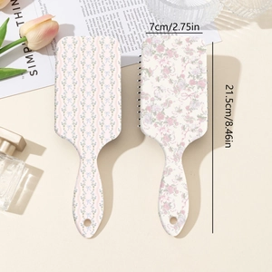 Floral print air cushion massage hairbrushes in blue and pink with hanging hole