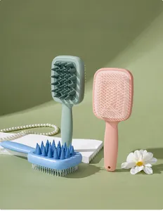 Close-up of double-sided silicone hair brush with coarse and fine teeth for scalp cleaning