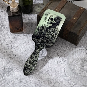 Gothic skull and red rose print hairbrush with massage air cushion on vintage wood