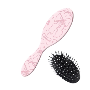 Brosse à cheveux rose avec motif de nœuds et picots de massage à coussin d'air