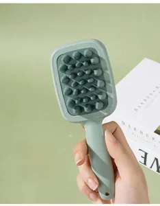 Detail of mint green silicone scalp massager brush with long handle and storage hole