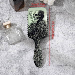 Detailed size measurement of gothic skull and rose print paddle hair brush, 21.5cm by 7cm