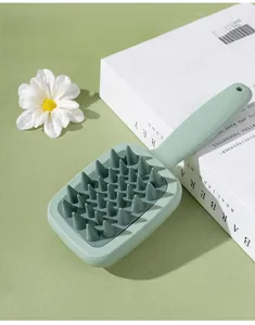 Detail of scalp massager brush featuring large cone-shaped bristles and ergonomic handle