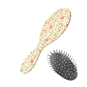 Floral oval cushion hairbrush with massage bristles and chic botanical pattern