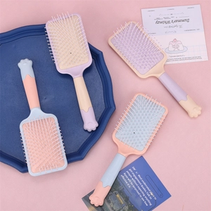Macaron paddle brush with cute cat paw handle and massage cushion in pastel colors
