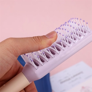 Handheld light purple vented hairbrush with massage bristles and cream white handle
