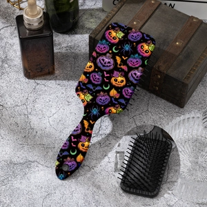 Detail of Halloween hair brush featuring vibrant pumpkin, ghost, and bat pattern prints