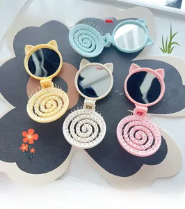 Detail of cute cat-ear hairbrushes with mirror in four pastel candy colors