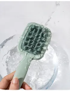 Waterproof silicone scalp massager brush being rinsed under running water for easy cleaning