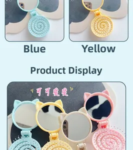 Macro detail of foldable cat-ear hairbrush with mirror in macaron colors and massage bristles