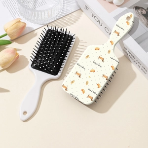 Dachshund print air cushion hairbrush set with wide tooth comb in a lifestyle setting