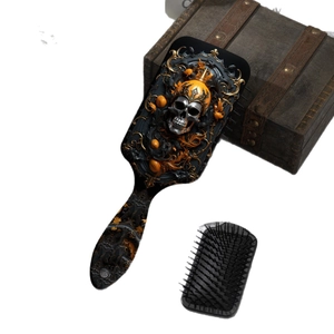 Gothic skull hairbrush set with golden Halloween patterns and crown on a vintage chest