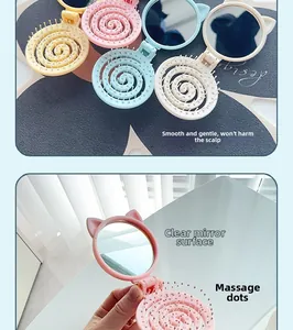 Detail of folding cat-ear hairbrush with integrated mirror and massage bristles