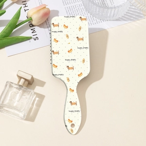 Detail of dachshund print paddle hairbrush with happy puppy text and round hanging hole