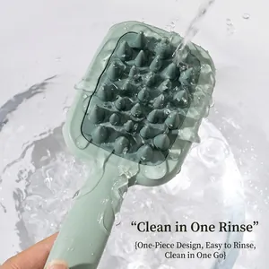 Silicone scalp massager hair brush with dual-sided handle being rinsed under water