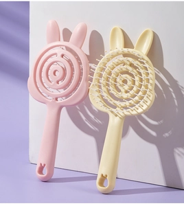 Macro detail of cute rabbit-shaped hollow hair combs in soft pink and beige colors