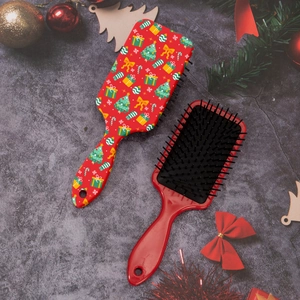 Detailed view of red Christmas hairbrush with festive patterns and holiday decor