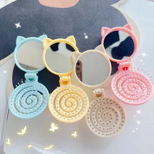 Foldable cat ear hairbrush with compact mirror in pastel gradient colors for easy styling