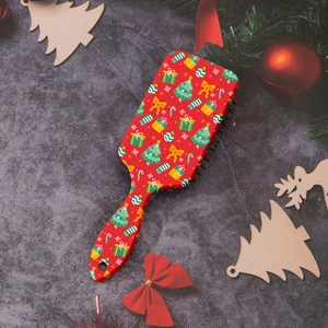 Christmas cushion hairbrush featuring snowflake and star prints on festive background