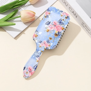 Floral air cushion hairbrush with rose and butterfly patterns on a light blue base