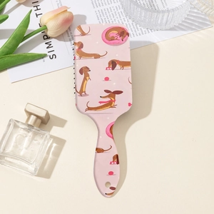 Détail d'une brosse à cheveux rose avec motif de teckel et décor de tulipes esthétiques