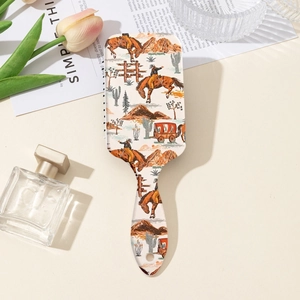 Detail of air cushion hair brush with western cowboy cactus print and retro desert pattern