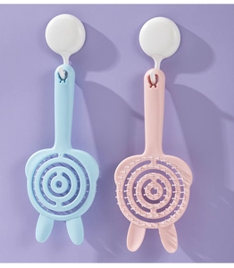 Detail view of cute rabbit hollow hair combs in pastel pink and blue hanging on hooks