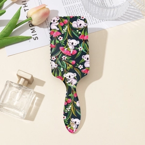 Détail de l'imprimé koala mignon et floral sur brosse à cheveux à coussin d'air portable