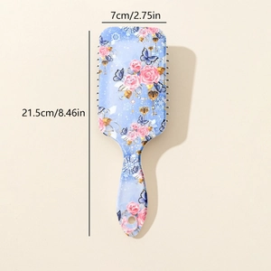 Detail showing dimensions of 21.5cm by 7cm on floral patterned blue hair brush
