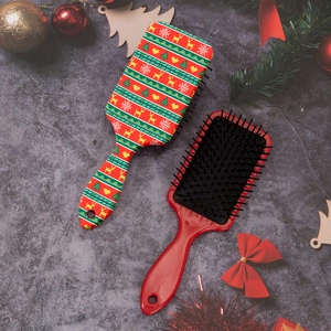 Detail of Christmas reindeer air cushion hairbrush with festive prints and soft massage pins