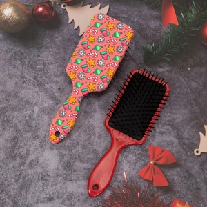 Detail of Christmas snowflake hairbrush with festive star patterns and massage bristles