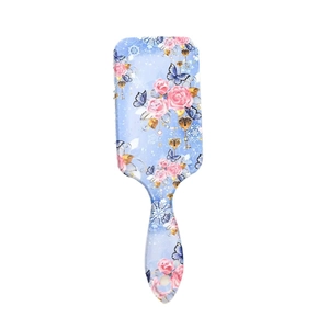 Blue air cushion hairbrush with pink floral rose and butterfly prints on white background