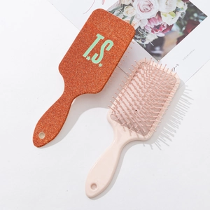 Orange and pink cushion hairbrush set with JS star print and massage bristles